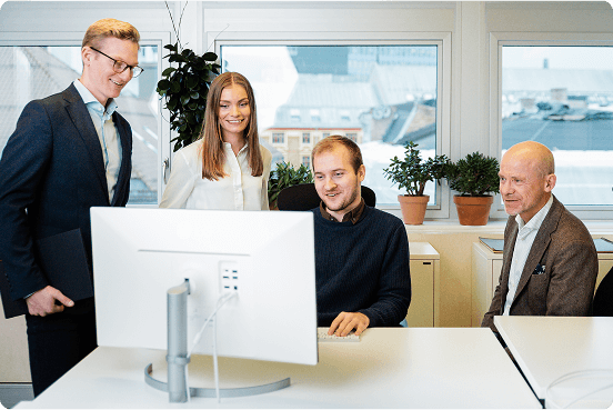 3 men and 1 woman looking at the monitor